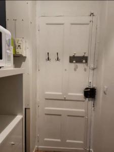 a white door with two knobs on it in a kitchen at Le petit Faure - Appartement 4 pers - Part-Dieu in Lyon