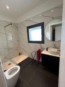 a bathroom with a toilet and a sink and a mirror at Villetta bifamiliare Jesolo in Jesolo +8 photos