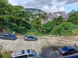 a group of cars parked in a parking lot at Evergreen Suites Baguio Condo Home Loft in Baguio