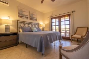ein Schlafzimmer mit einem Bett und einem Stuhl und einem Fenster in der Unterkunft Sandy Beach Costa Diamante E15 House Game Room Dog Friendly in Puerto Peñasco + 37 Fotos