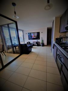 a kitchen and living room with a view of a living room at Cavancha Exclusivo in Iquique +13 photos