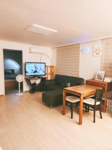 a living room with a couch and a table at Peace and Quiet in Seoul