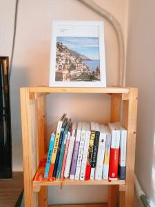 a book shelf filled with books with a picture on top at Peace and Quiet in Seoul