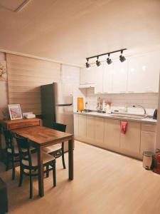 a kitchen with a wooden table and a refrigerator at Peace and Quiet in Seoul