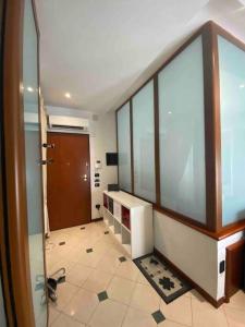 a large room with a door and a tile floor at Elegante appartamento nel cuore di Ferrara in Ferrara