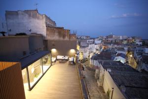 a view of a city from the balcony of a building at Casa Nera GuestHouse in Montescaglioso
