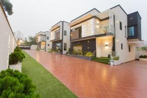 a house with a red tiled driveway at Kumasi Luxury Apartments @ The Fairview in Kumasi