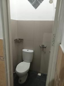 a small bathroom with a toilet and a shower at Hotel Srikandi Baru in Yogyakarta