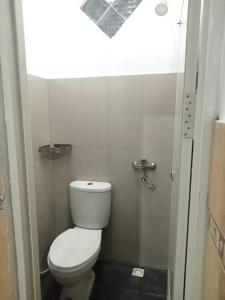 a small bathroom with a toilet and a window at Hotel Srikandi Baru in Yogyakarta