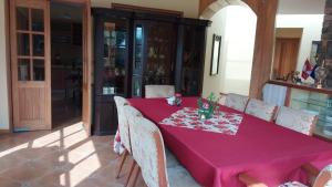 a dining room table with a pink table cloth at Las buganvilias in Pachacamac