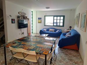 a living room with a table and a blue couch at Terrazas del Sur in Los Abrigos
