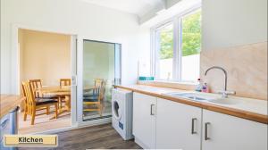 a kitchen with a sink and a table at Mardon Holiday Home STL Licensed in Inverness