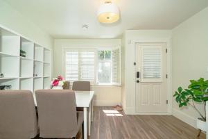 a dining room with a table and chairs and a window at Van West Serene Retreat Close to UBC and Downtown in Vancouver