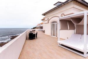 a balcony of a house with a view of the ocean at Residencial Real Guest House in Sintra