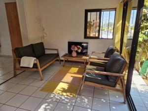 a living room with two chairs and a fireplace at Au village naturiste, Villa vue Marina in Cap d'Agde