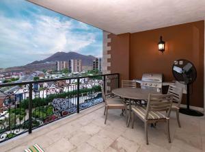 a balcony with a table and chairs and a view at Exquisite 3BR Condo Ocean Views Access Resorts in Cabo San Lucas