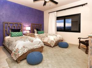 a bedroom with two beds and a window at Stunning 3BR Condo with Ocean Views, Golf Course & Resort Amenities in Cabo San Lucas +110 photos