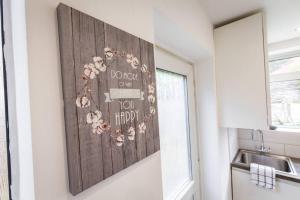 a kitchen with a wall art with flowers on it at Windsor House 3 Bedrooms Sleeps 8 in Manchester