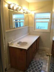 a bathroom with a sink and a mirror at 1949 Sweet Sage House, CLOSE to Airport, Temple and Highway in Idaho Falls