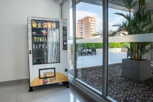 a drink vending machine in a building with a window at Distrito 90 in Barranquilla