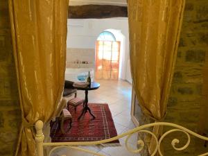 a room with yellow curtains and a table in a room at Il Vicolino in Cortona