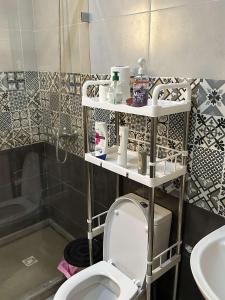 a bathroom with a toilet and a sink at Appartement de Lux Hay Al MATAR in Nador