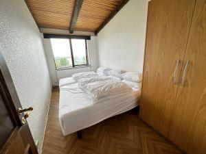 a small bed in a room with a window at House in Reykjavik - Birta Rentals in Reykjavík