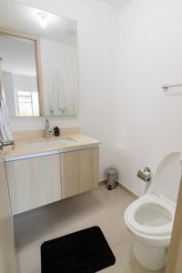 La salle de bains est pourvue de toilettes, d'un lavabo et d'un miroir. dans l'établissement Habitech soho 55-2, à Barranquilla