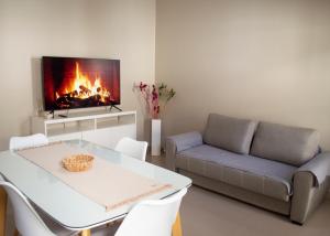a living room with a couch and a table and a fireplace at Bruno`s Haven in Neuquén
