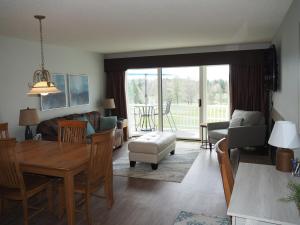 a living room with a table and a dining room at The Grand Getaway - Gorgeous And Great Location! in Traverse City