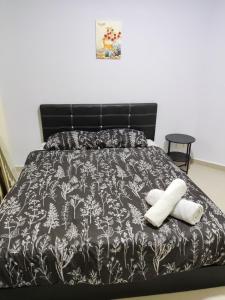 Postel nebo postele na pokoji v ubytování JoJo Homestay Tiara Residence