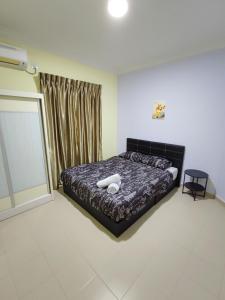 a bedroom with a bed and a window at JoJo Homestay Tiara Residence in Desaru