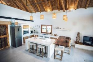 a kitchen with a large white island in a room at Jungle Shacks : Hoku Casita in Popoyo