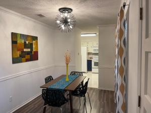 a dining room with a table and chairs and a chandelier at Lucky #9 Hot Springs in Hot Springs