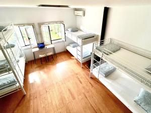 a room with four bunk beds and a wooden floor at Carcavelos Summer Beach in Carcavelos