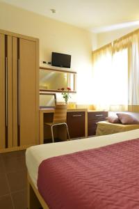 Postel nebo postele na pokoji v ubytování Hotel Rosignano