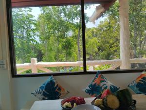 a window in a room with a bowl of food on a table at Dream seaview bungalows in Haad Pleayleam