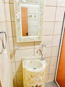 a bathroom with a sink and a mirror at Casa con alberca. in Tamazunchale