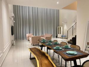 a living room with a wooden table and chairs at Puchong New Private Pool & Jacuzzi up to 30 Pax in Puchong