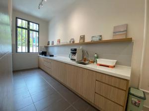 a kitchen with a sink and a counter top at Puchong New Private Pool & Jacuzzi up to 30 Pax in Puchong