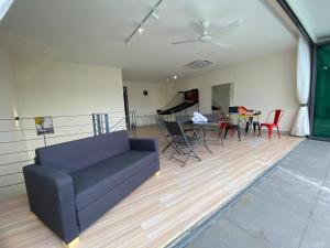 a living room with a couch and a table and chairs at Puchong New Private Pool & Jacuzzi up to 30 Pax in Puchong