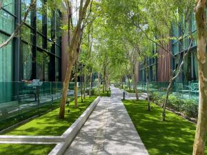 a walkway through a park next to a building at Puchong New Private Pool & Jacuzzi up to 30 Pax in Puchong