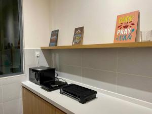 a microwave sitting on a counter in a room at Puchong New Private Pool & Jacuzzi up to 30 Pax in Puchong