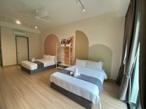 a hotel room with two beds and a window at Puchong New Private Pool & Jacuzzi up to 30 Pax in Puchong