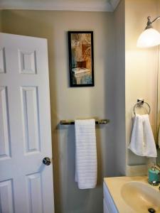 a bathroom with a sink and a white door at Luxury Basement Apartment LA CASA in Winchester