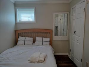 a bedroom with a bed with a towel on it at Luxury Basement Apartment LA CASA in Winchester