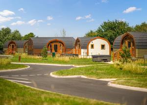 a group of wooden buildings on a road at Wild Acre Village At Sundown Adventureland in Retford