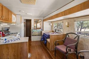 an rv kitchen with a sink and a table at Twin Falls Luxury Glamping - Stargazer in Boerne