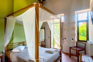 a bedroom with a canopy bed and a window at Splanzia Boutique Hotel in Chania
