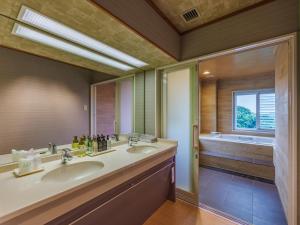 a bathroom with two sinks and a large window at Todaya in Toba